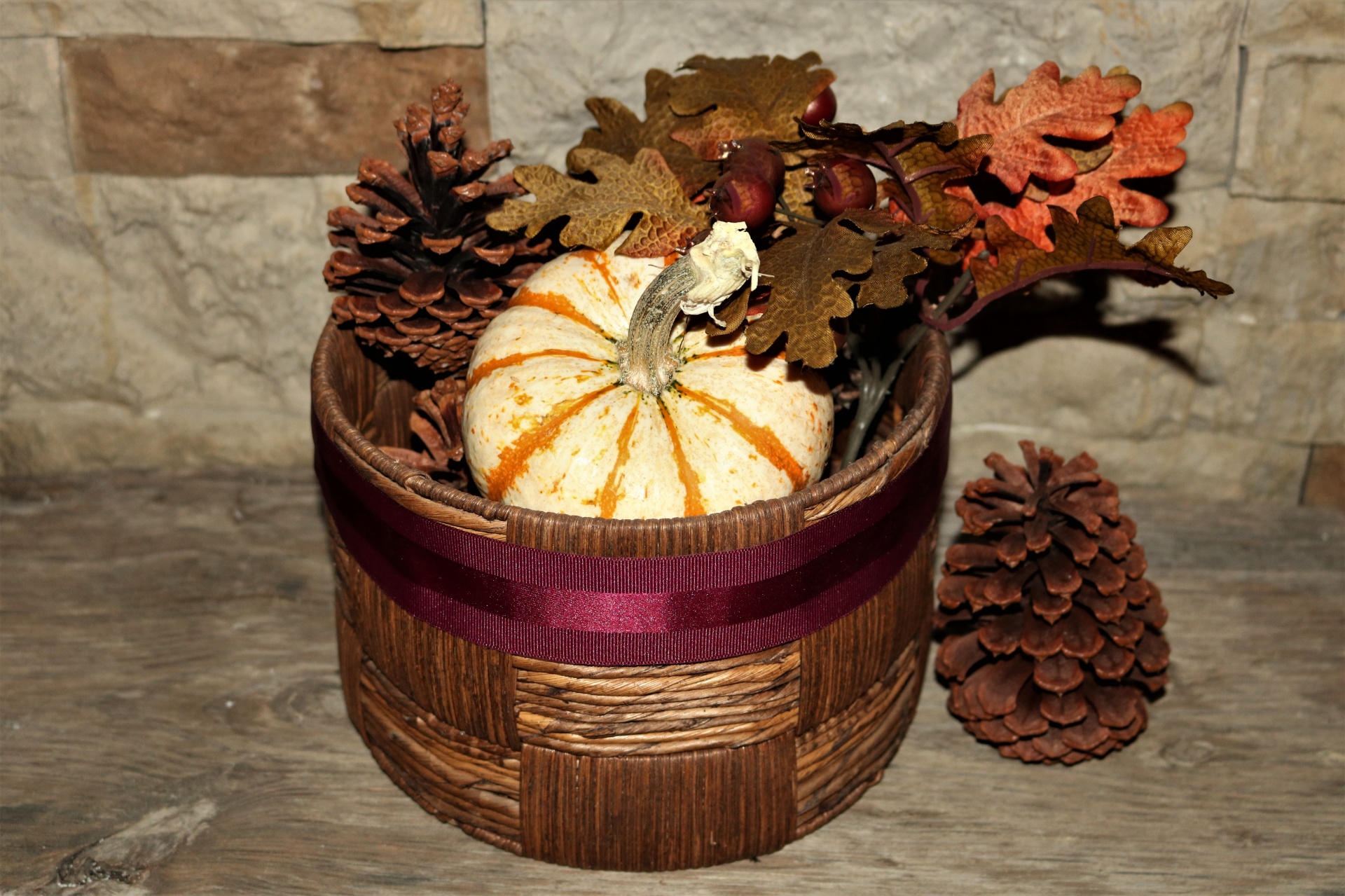 Pumpkin And Pine Cones In Basket