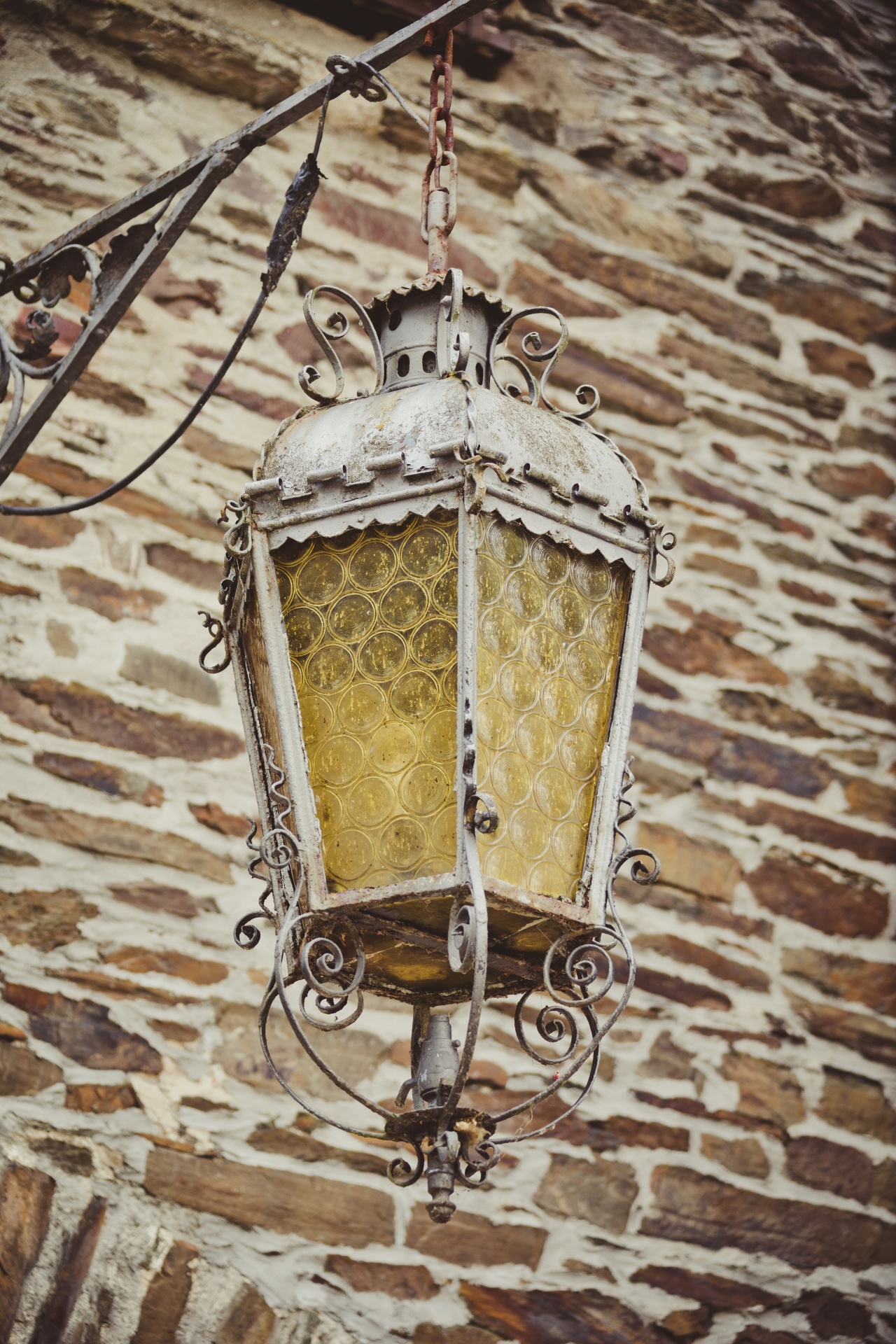 Historic street lamp on castle's stone wall