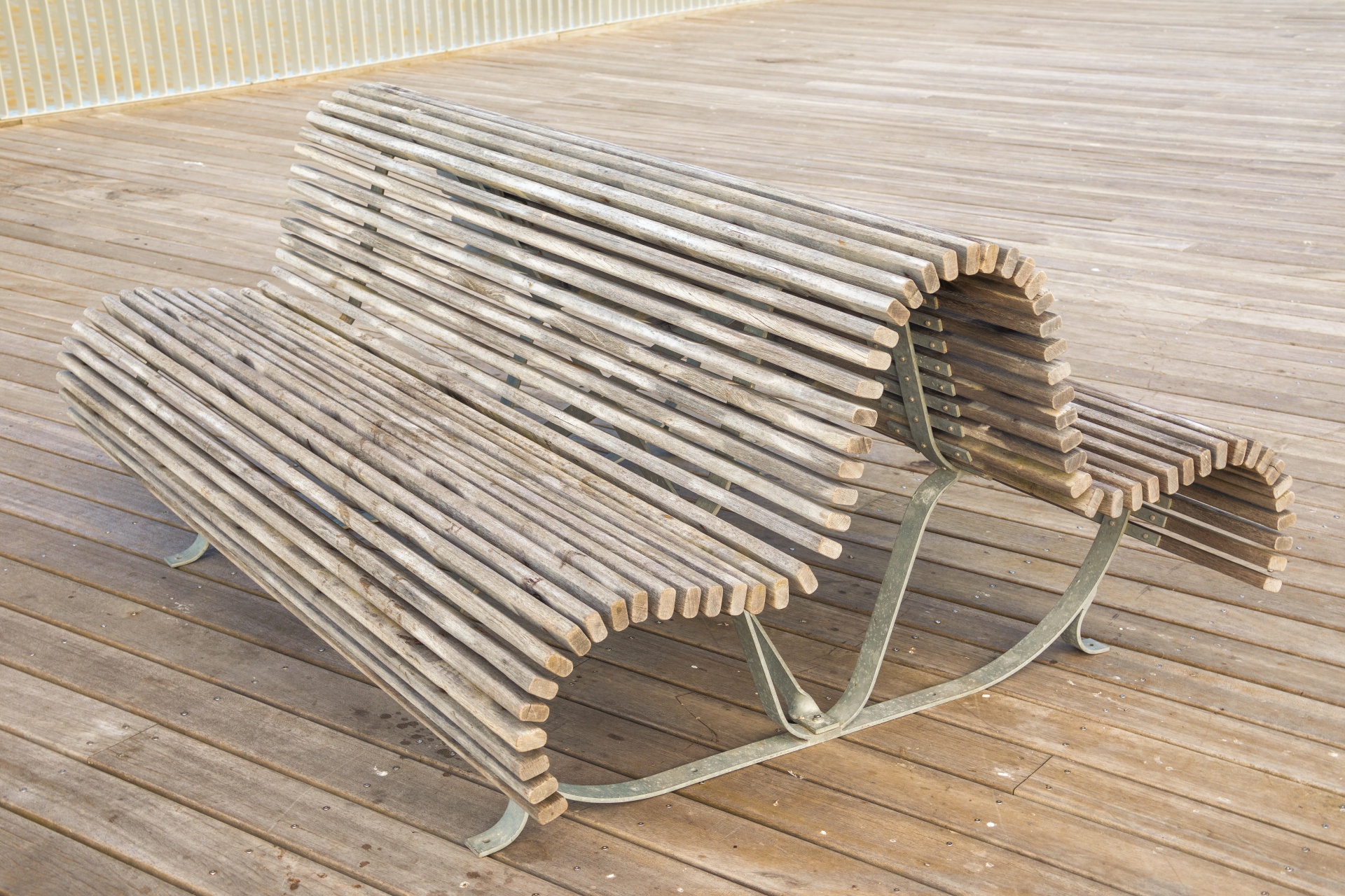 Wooden curvy bench on a pier