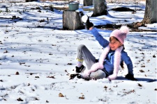 Little Girl Holding Up A Snowball