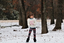 Little Girl Making A Snowball