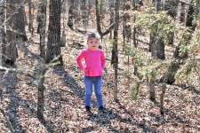 Little Girl Standing In The Woods