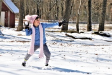 Little Girl Throwing Snowball