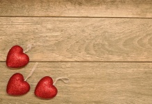 Three Red Glitter Hearts On Wood