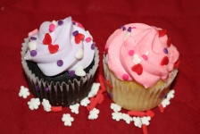 Two Cupcakes On Red Close-up