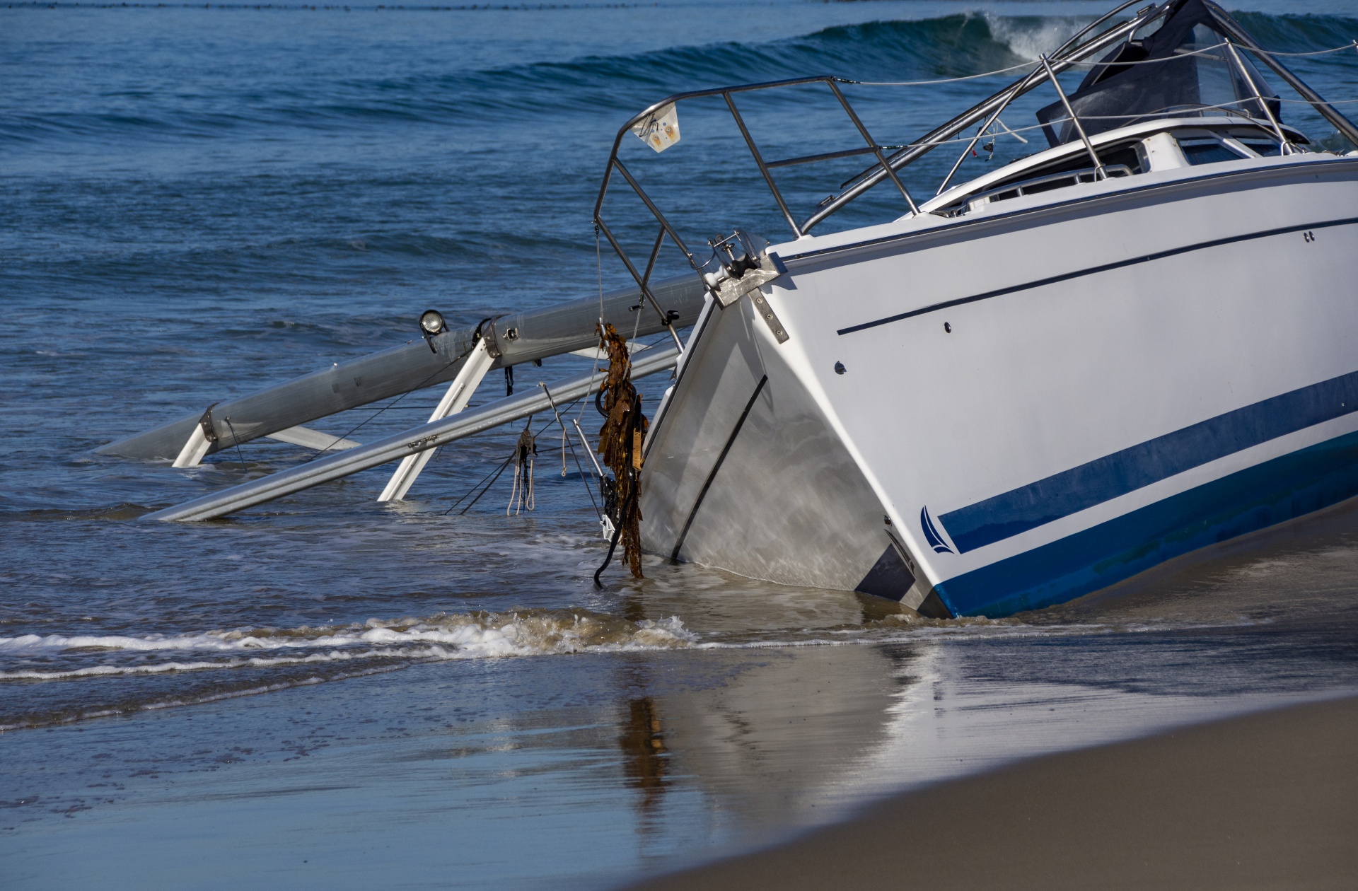 sailboat washed up on ocean shore