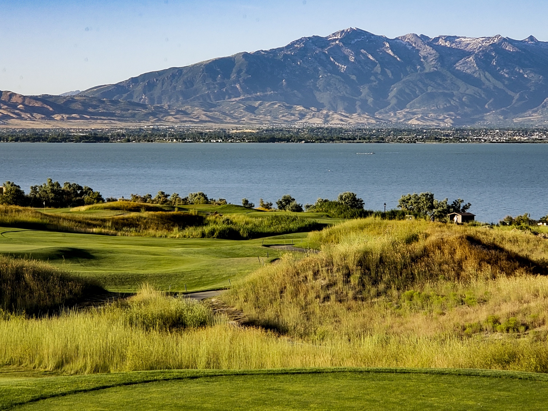 Golf Course overlooking a lake and mountains