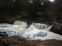 River Rushing Over A Broken Weir