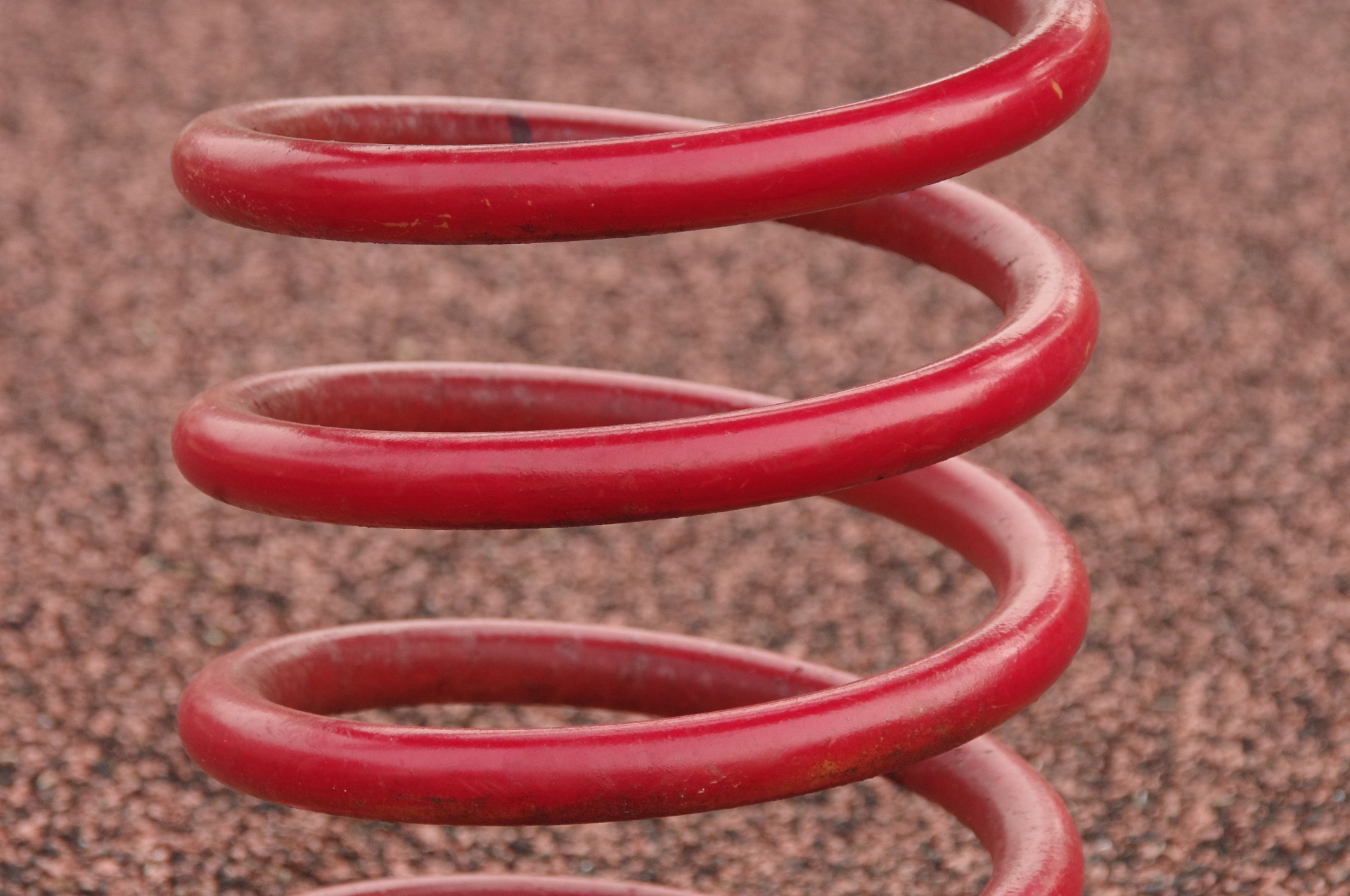 Large red spiral coil against red background