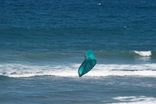 Blue Windsurfer Sail Over Surf