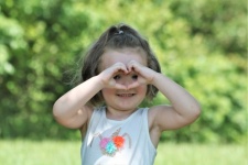 Little Girl Making Heart With Hands