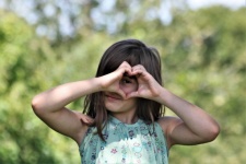 Young Girl Making Heart With Hands