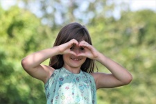 Young Girl Making Heart With Hands