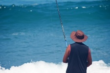 Fisherman Fishing On A Beach