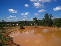 Hikers On Bank Of Water Hole