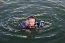Little Girl Swimming In Lake