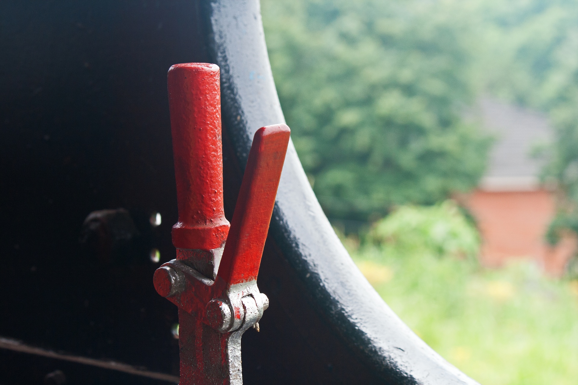 red painted lever inside cabin of an old steam locomotive