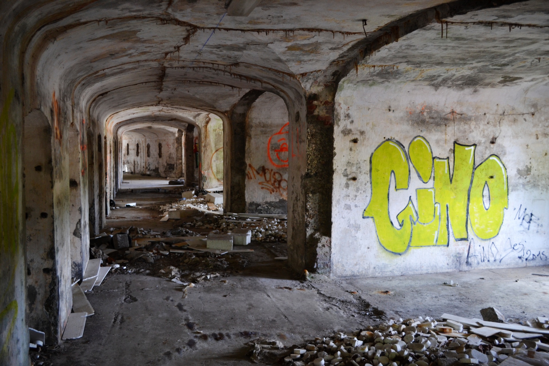 Abandoned fortress corridor with graffitti