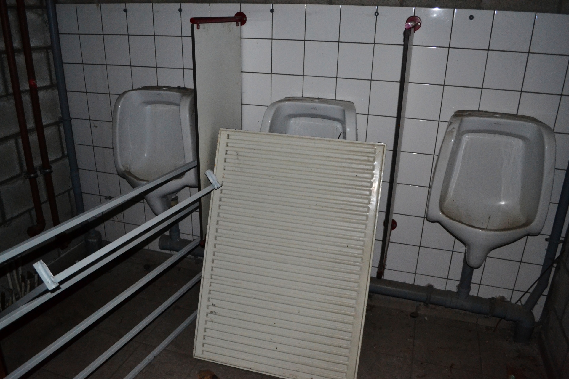 Abandoned restroom in factory with radiator