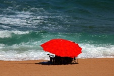 Large Red Umbrella On The Beach