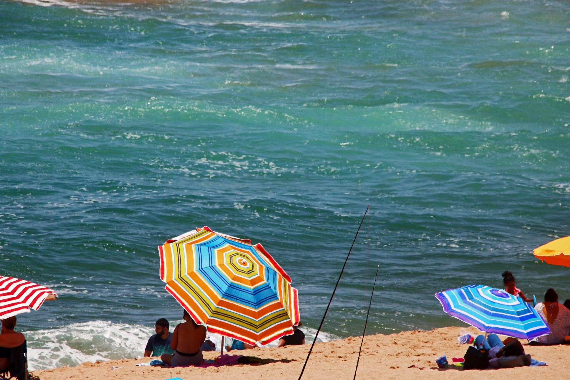 Colourful Parasols On The Beach