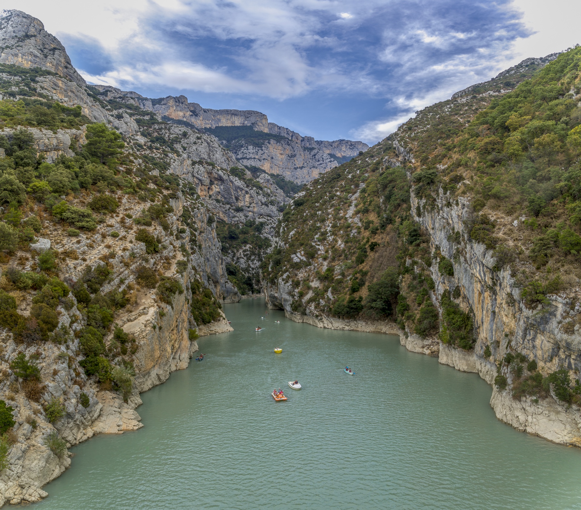 Verdon, France on Vacation - Tourists enjoying a warm summer day in the Gorges du Verdon, renting boats to explore the gorges or feeling adventurous and even going for a swim.