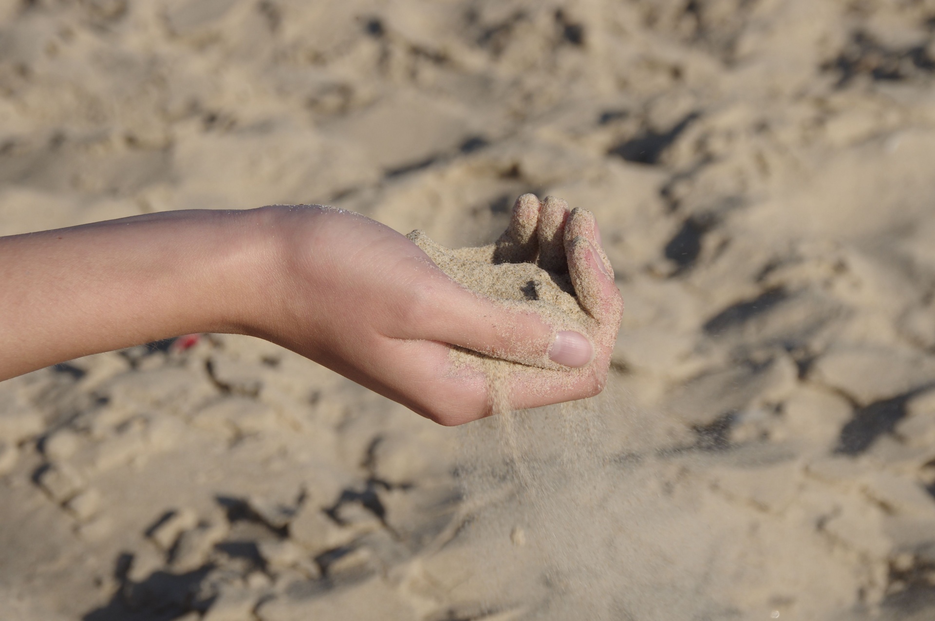 Hand Playing In Sand On Beach