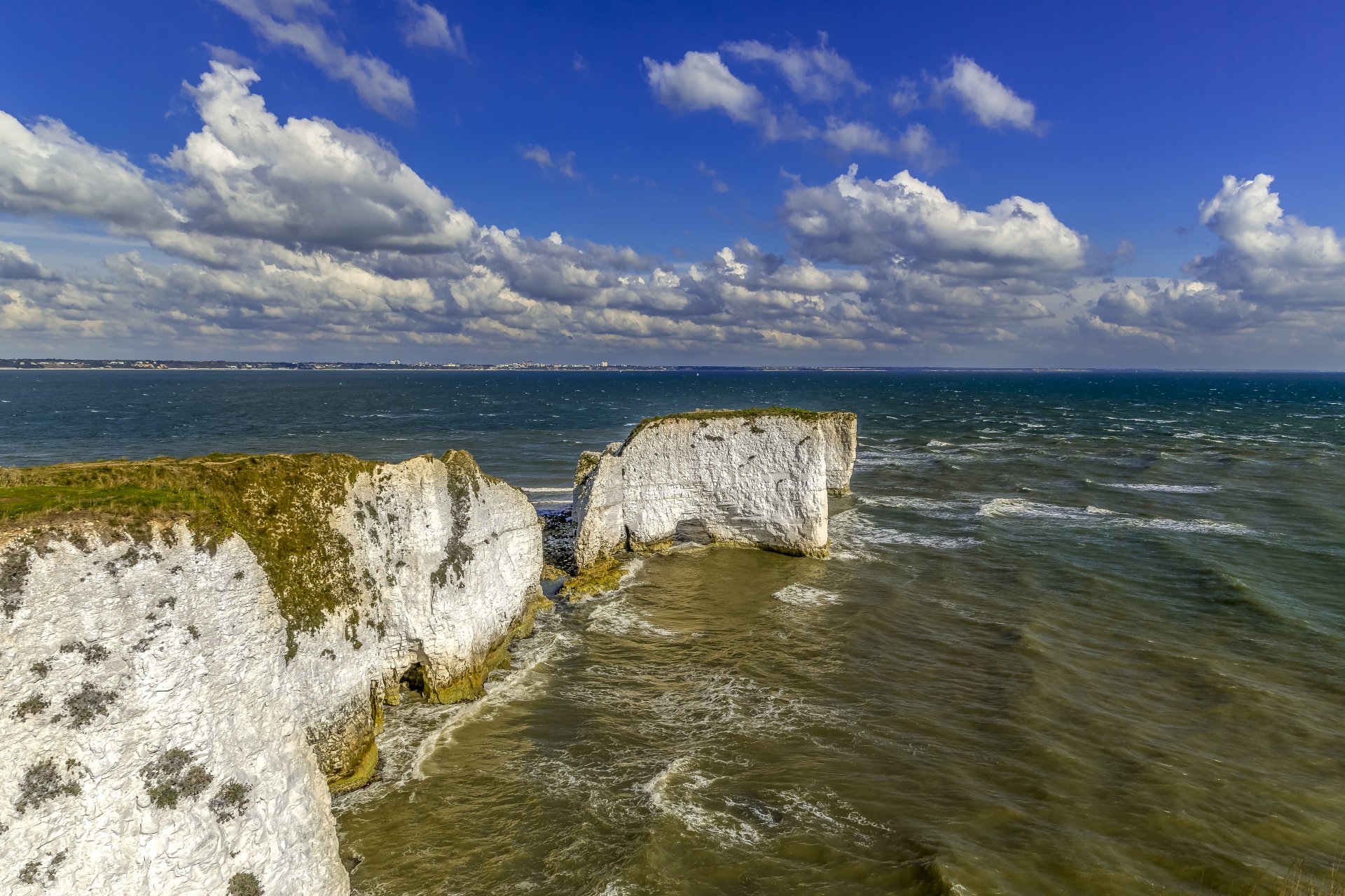 Old Harry Rocks are three chalk formations, including a stack and a stump, located at Handfast Point, on the Isle of Purbeck in Dorset, southern England. They mark the most eastern point of the Jurassic Coast, a UNESCO World Heritage Site