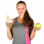 Fit Woman With A Drink And An Apple