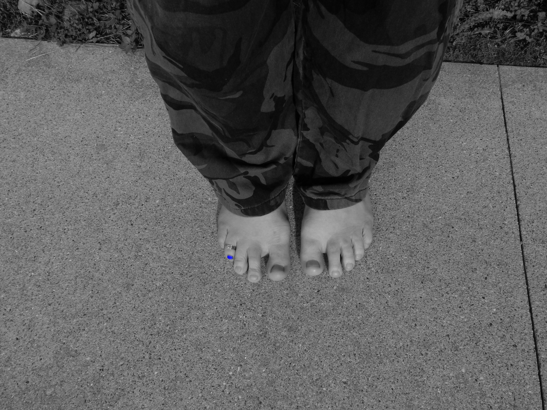 barefoot guy with his toe nail painted blue wearing a toe ring