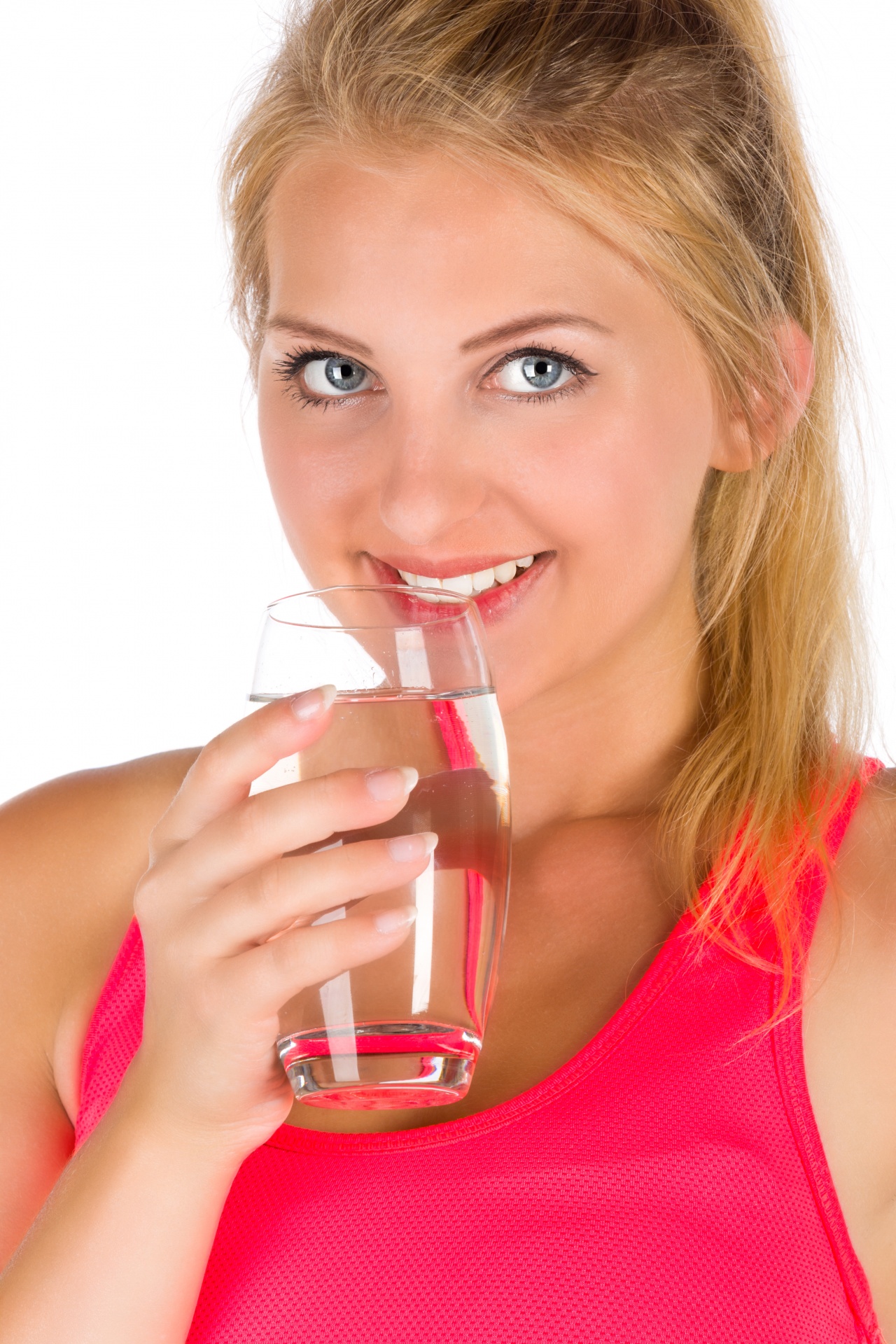 Young fit woman holding a glass of water isolated on white background