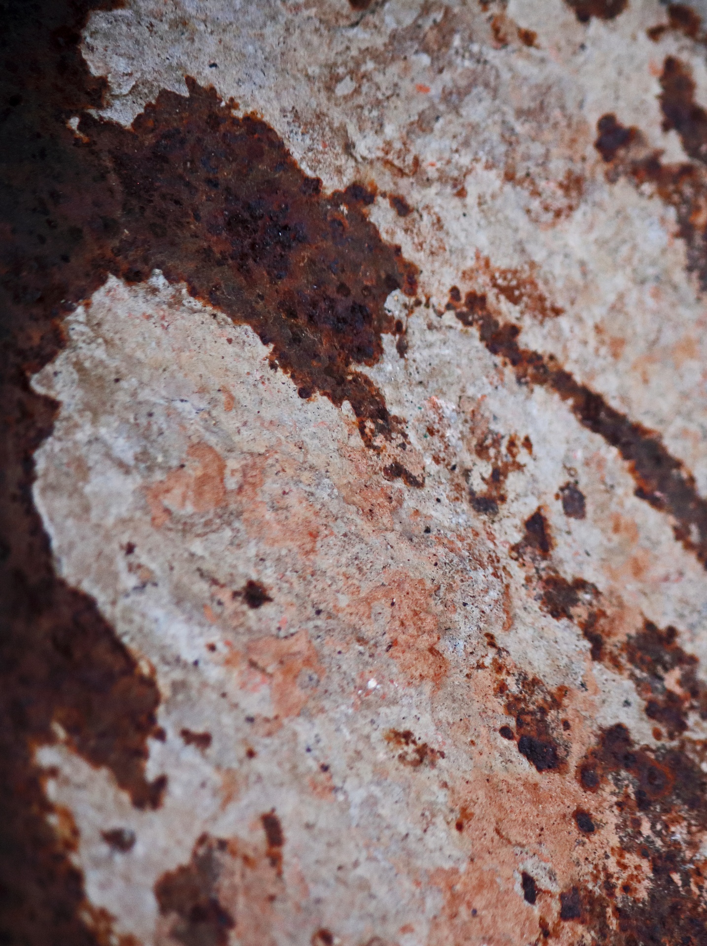 texture of remnant dry concrete on surface of old rusted wheelbarow