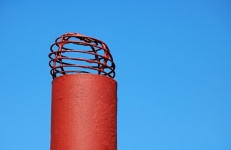 Red Painted Air Vent On A Roof