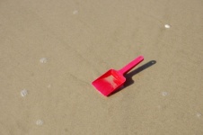 Red Spade Left Behind On Beach