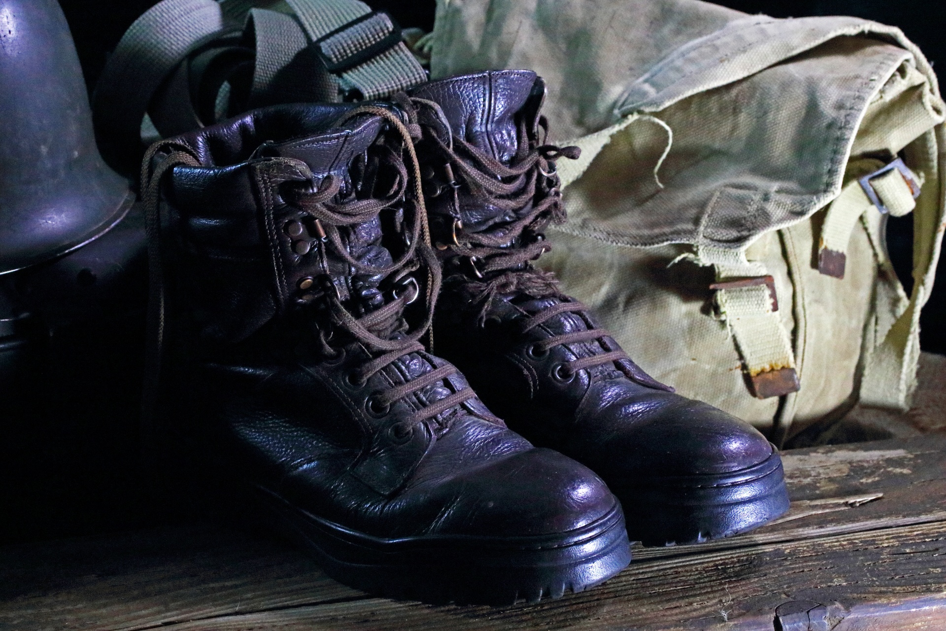 combat boots with canvas bag and metal helmet