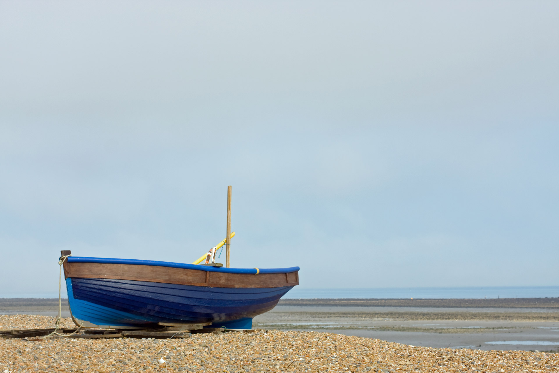 Blue wooden fishing boat on the beach