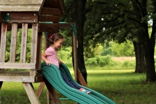 Little Girl Playing On Slide