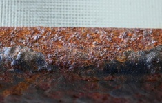 Rusted Metal Edge Of A Glass Top