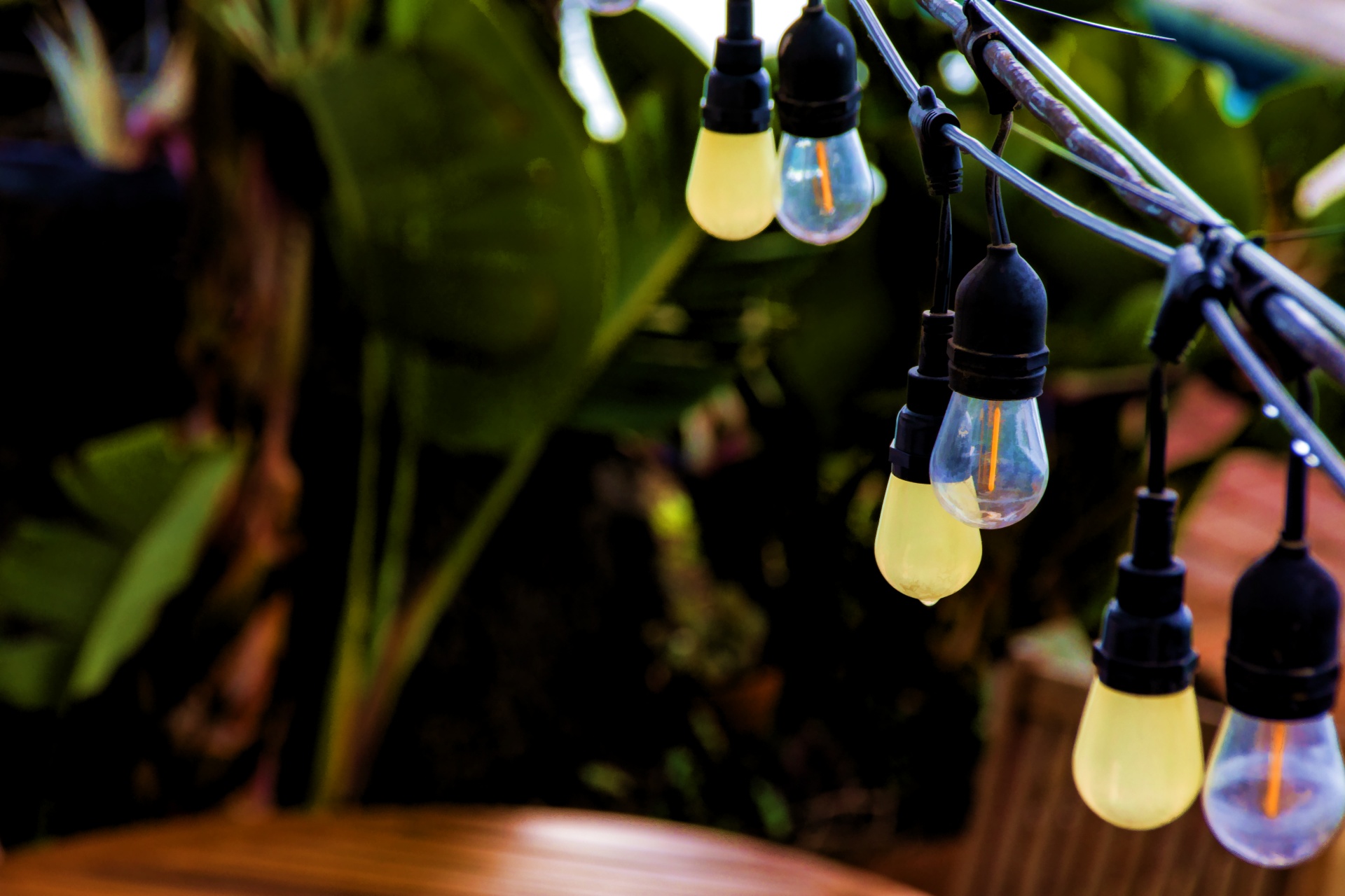 artistic rendering of a string of translucent and clear hanging patio lights