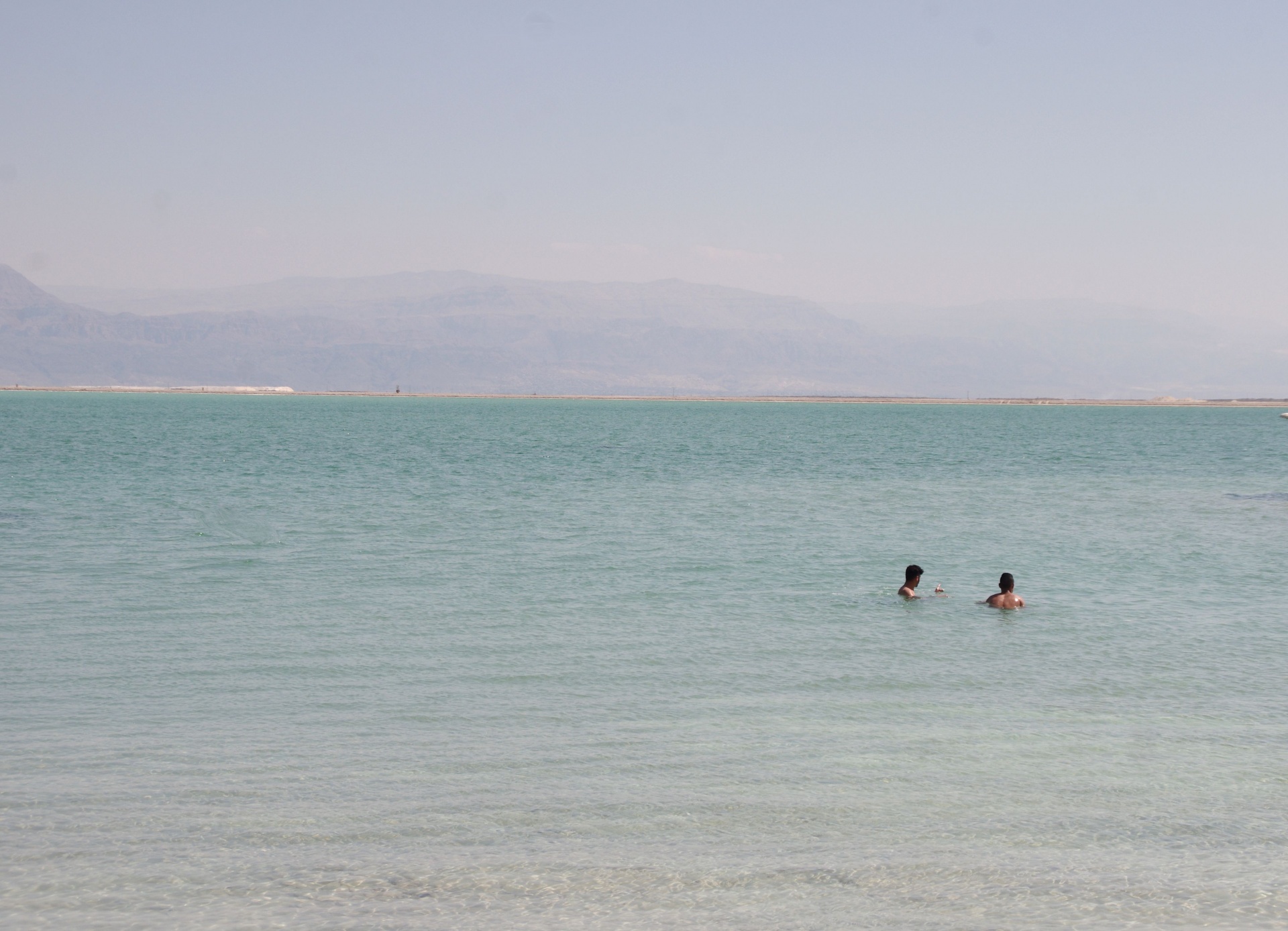 Two People Floating In The Dead Sea