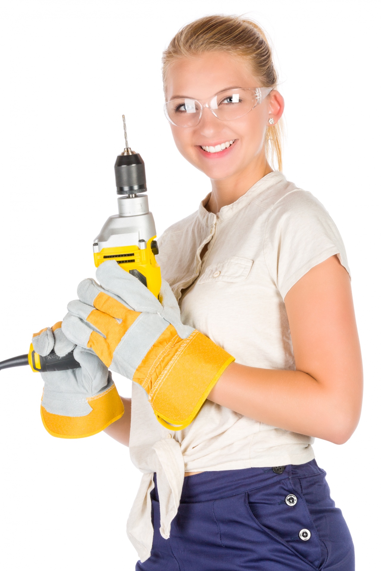 Young woman with a drill wearing safety goggles isolated on white background