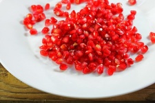 Pomegranate Seeds On A White Plate