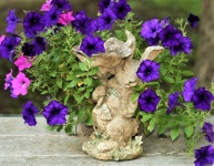 Purple Petunias And Bunny Statue