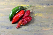 Red And Green Chilis On Grey