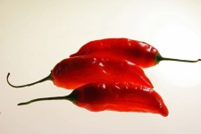 Red Chilis On A Lit Background