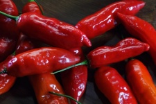Red Chilis On A Wooden Surface