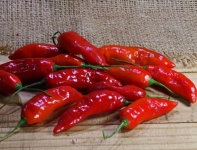 Red Chilis On A Wooden Surface