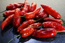 Red Chilis On Polished Black Marble