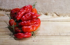 View Of Red Chilis On Wooden Board