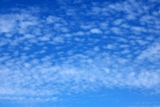 White Tufts Of Cloud In A Blue Sky